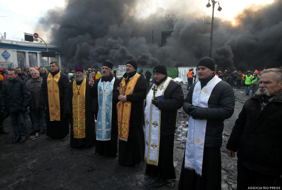 zoetica:  Tense, fascinating photos of orthodox priests at the protests in Kiev (Source).
