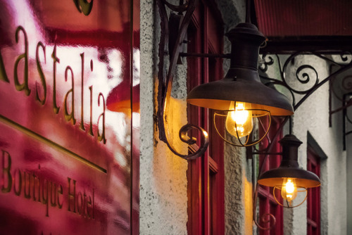 Cozy and inviting front door lights. Welcome to Kastalia Boutique Hotel. Delphi | Greece