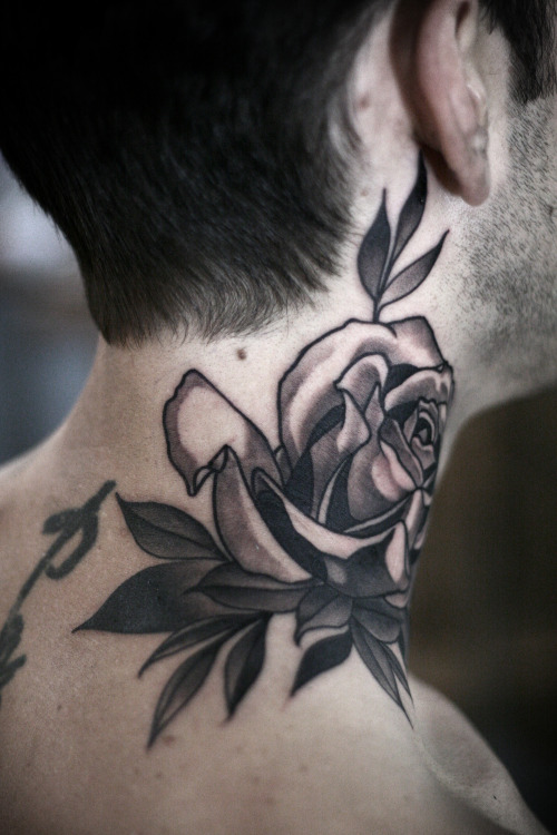 Super cool graphic black and grey rose on the neck by @seanwrighttattoos