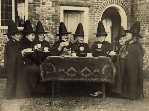 onceuponatown:Eight women in high hats having tea. They are not a group of witches but the members o