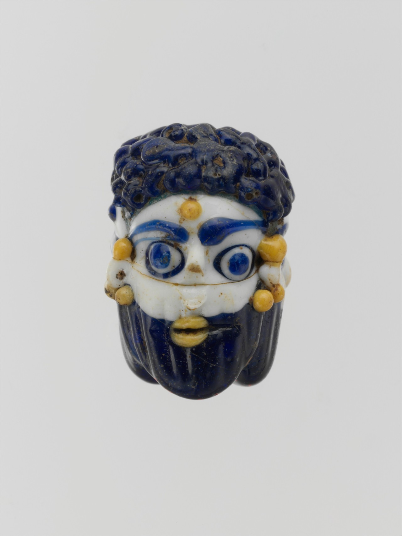 ancientart:  Phoenician or Carthaginian glass head pendants. The first dates to theÂ 5th