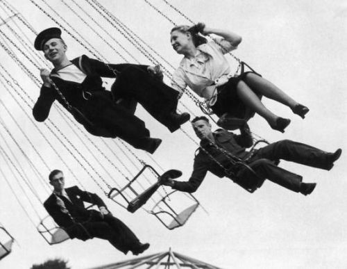 5th August 1940: A sailor and companion enjoy a ride at Blackheath, London, fun fair. (Photo by Harr