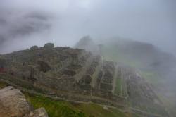 the mist slowly revealing machupicchu  Peru.