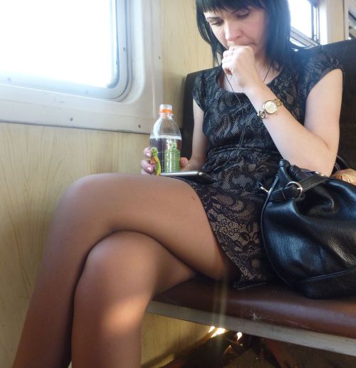 Woman in short dress and tan pantyhose caught in the train.Woman in pantyhose