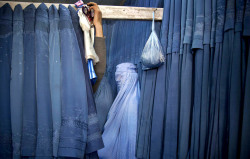 letswakeupworld:  A woman waits in a changing room to try on a new burqa at a shop in Kabul, Afghanistan. (Photo Credit: Anja Niedringhaus)