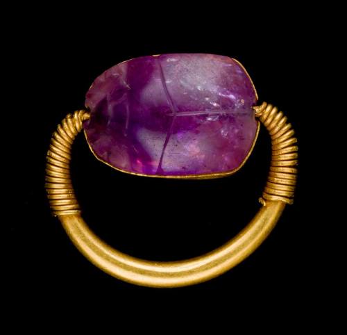 egypt-museum:Amethyst Scarab RingAncient Egyptian amethyst scarab set in a gold ring. Now in the Wor