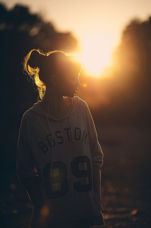 silhouette of a girl in the sun by murray mitchell