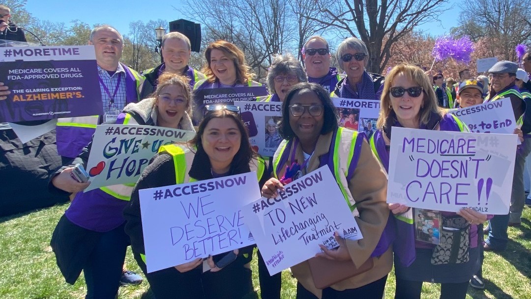 Volunteer advocates and Association staff pose for a picture at a rally on the White House lawn. Signs read #accessnow and #moretime