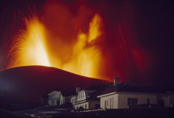 Unrar:  Kirkjufell Volcano Erupting Above The Town Of Vestmannaeyjar, Iceland, Emory