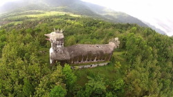 nambroth:  becausebirds:  Deep in the forests of Central Java, towering above the surrounding trees, lies an abandoned, crumbling church in the shape of a giant chicken with its beak open mid-squawk. Locals have dubbed it the “chicken church.” 🐔