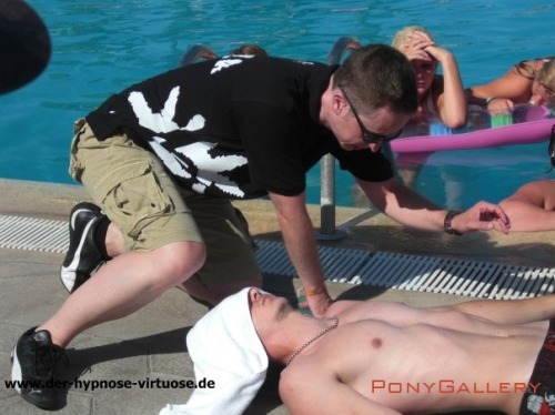 Cute shirtless guy gets hypnotized by the pool.