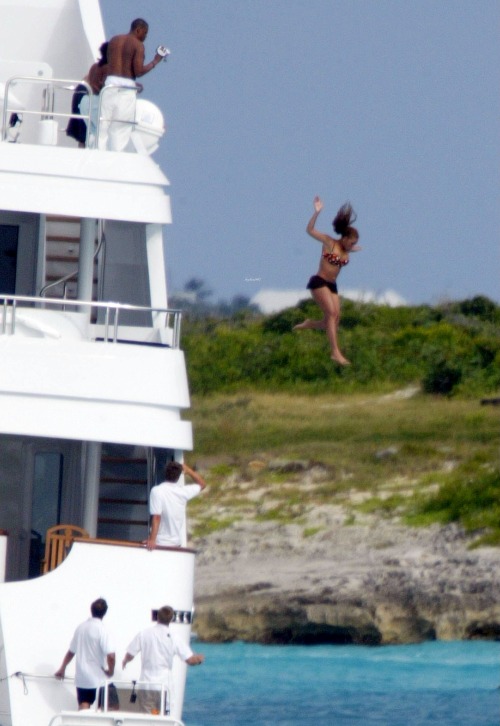 beyhive1992:   A recent photo from their New Year’s vacation in St. Barths shows Beyoncé jumping into the water off the bridge of a three-story, 14-foot yacht while Jay captures the moment with a video camera. It was a long way down. “Yeah it was,”