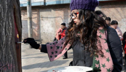 karenhurley:  Wang Yue calls the tree-hole paintings “meitu” which means “beautiful journey.” The paintings on the trees have brightened the city during the dull, grey winter. 