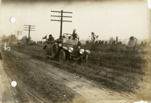 Motorists in R-C-H press automobile on road between Muskegon and Grand Rapids during the Chicago Rel