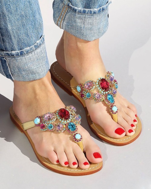 Beautiful ornate sandals on pretty feet.