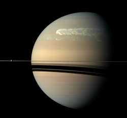 astronomyblog: Rhea and storm on Saturn Image