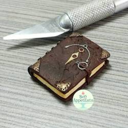bon-appeteats:  Too excited to wait and share, so here’s my next piece for my miniature Halloween scene: a spellbook!   The pages and cover are aged to give it a worn look. There are tiny watch parts used for decorations and the buckle. :D  I plan on