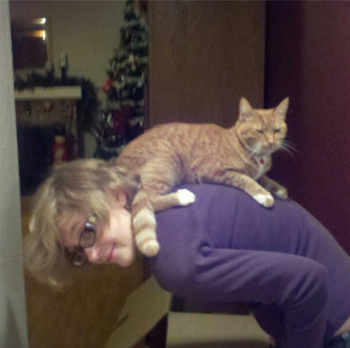 Hi! This is me and my cat Pumpkin. We think she was an american shorthair, but as she was a rescue c