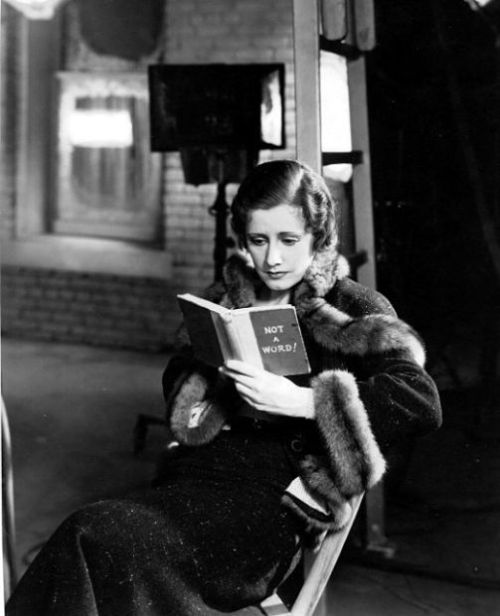 Irene Dunn reading on the set of Back Street, 1932.John Boles appears as Saxel and Irene Dunne portr