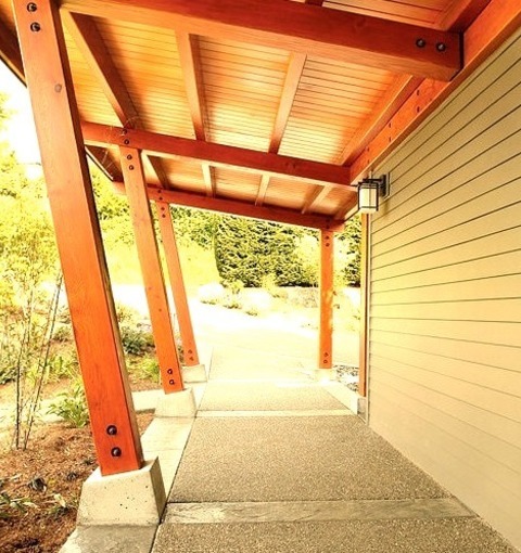 Porch Seattlemedium-sized, Fashionable Side Porch Photo With A Roof Extension In Stamped Concrete.