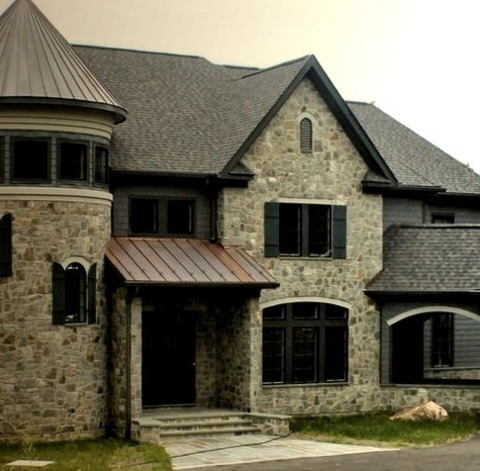 Transitional Exterior - StoneLarge Transitional Two-story Stone House Exterior Photo