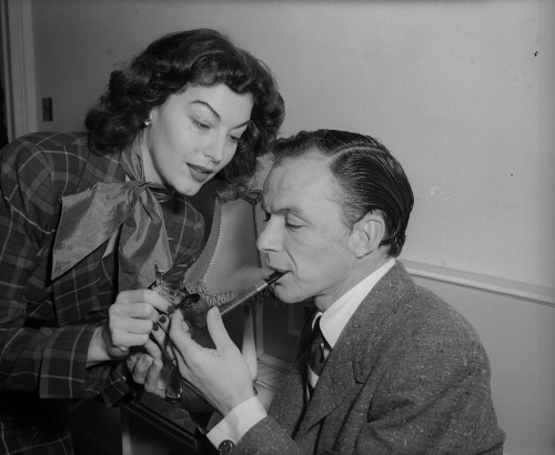 Ava Gardner lighting a pipe for Frank Sinatra, December 1951. Photograph by Walter Bellamy.