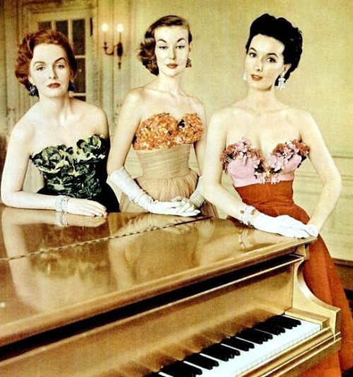 Models at piano wearing ornamental bras covered with leaves, flower petals, and velveteen blossoms b