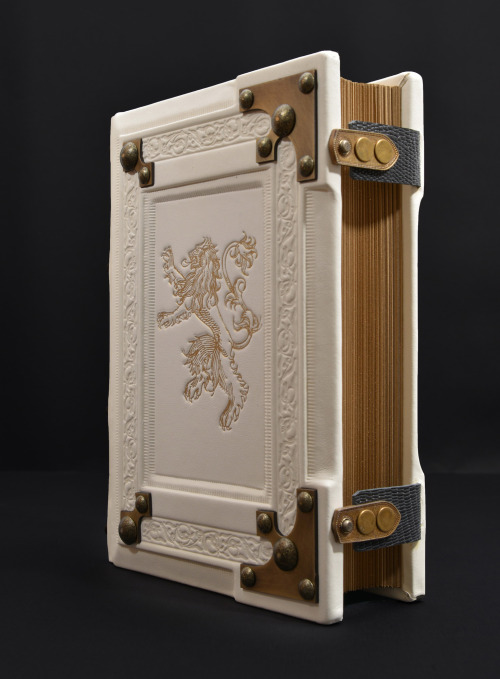 Large white leather book with the gilded lion… 8" x 10" large, 3" thick, 600 p