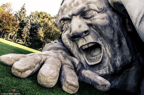 sixpenceee:  Hungarian artist Ervin Herve-Loranth is responsible the enormous sculpture, entitled ‘Feltépve’ which translates as ‘ripped up’ or ‘pop up’. The gigantic man appears to be emerging from underneath a blanket of grass. It was