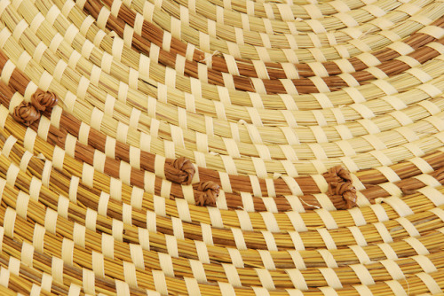 Sweetgrass rice fanner with pine knotsMultiple views of a circular, flat sweetgrass basket with a ha