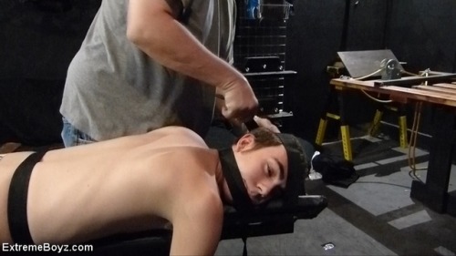 Maxx is strapped to the spanking bench for some nice tickling and a firm ass warming at www.ExtremeB