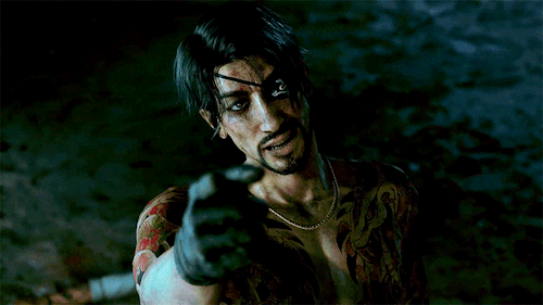 Majima standing outside at night, he has a hand forward gesturing a come here motion. His appearance looks mused, his face and chest are bruised and slightly bleeding.