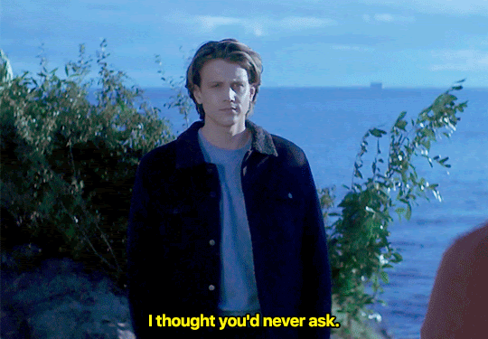 GIF FROM EPISODE 2X18 OF NANCY DREW. ACE IS STANDING AT THE BLUFFS. HE SAYS "I THOUGHT YOU'D NEVER ASK" AND TAKES A STEP FORWARD.