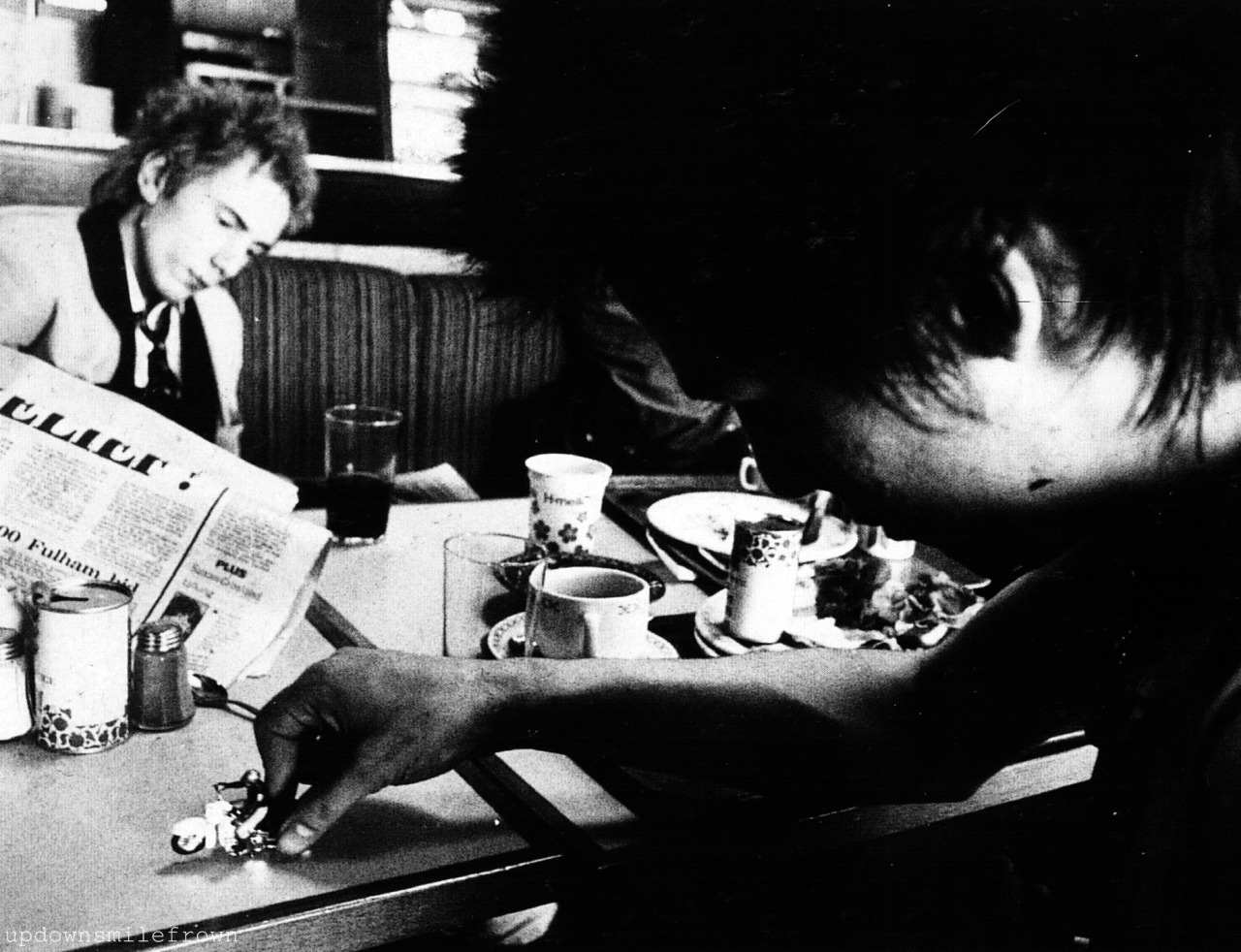 theunderestimator-2:
“  ”We’re so pretty, oh So pretty, We’re Vacant …And We Don’t Care!”
Johnny Rotten reading the newspaper and Sid Vicious playing with a toy biker in Norway, during the days of the 1977 Sex Pistols Scandinavian Tour.
”