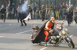 choke-me-elmo:    It’s a luchador, on a motorcycle, at a protest, being fired on by riot police, in real life.   