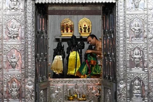 A Hindu priest prepares an idol in a temple in Mumbai, India, as places of worships in Maharashtra s