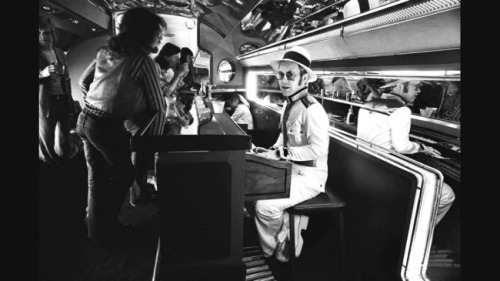 blondebrainpower:  Elton John playing the piano in the bar of his private jet, 1976