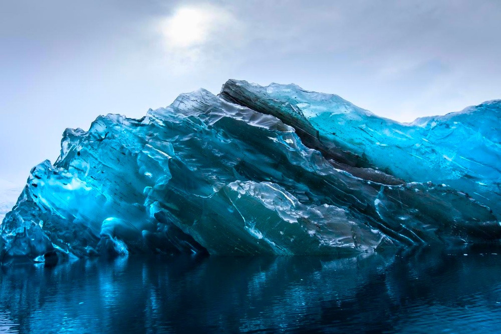 nubbsgalore:  the submerged underside of an iceberg becomes revealed when it flips,