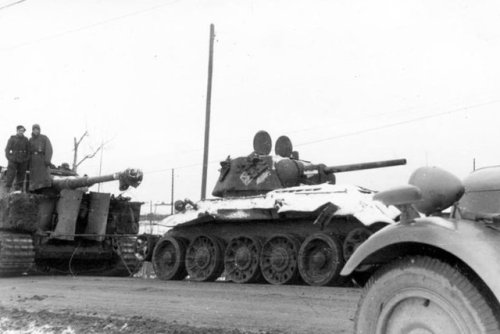 ww1ww2photosfilms:A Tiger tank and a knocked-out Soviet T-34 during the rescue operation of the Germ