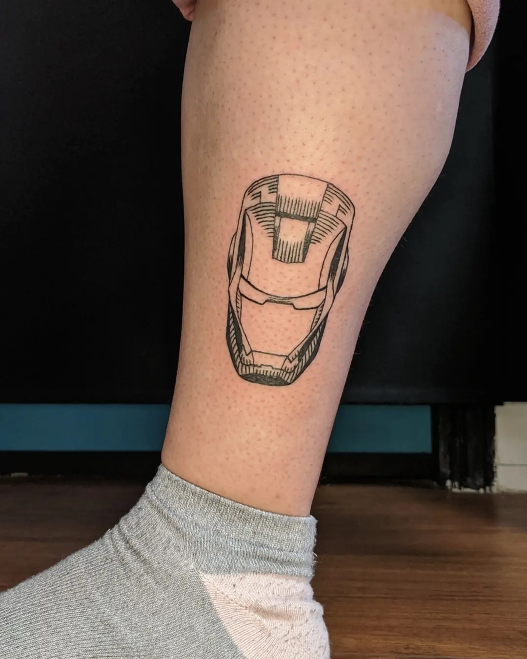 Black and Grey style Iron Man tattoo located on the