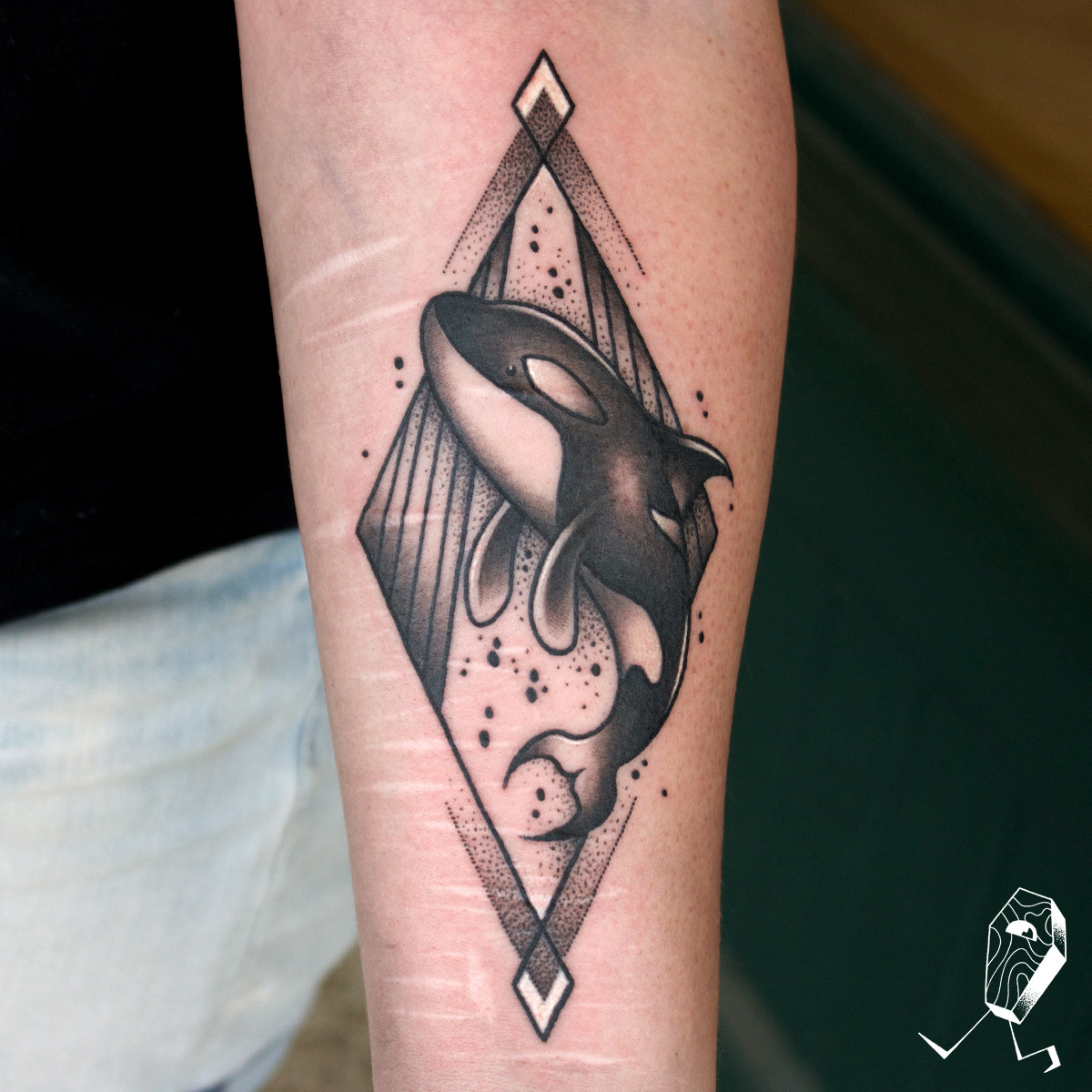 Flying fish tattoo on the right upper arm