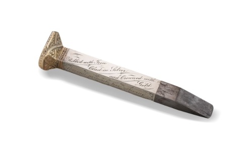 A STEEL RAILROAD SPIKE CLAD IN GOLD AND SILVER USED IN THE CEREMONY MARKING THE COMPLETION OF THE TRANSCONTINENTAL