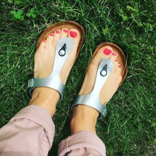 Cute thong Birkenstock sandals on pretty feet.