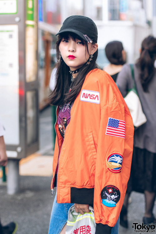 15-year-old Japanese student Kaya on the street in Harajuku wearing a NASA bomber jacket over a Slip