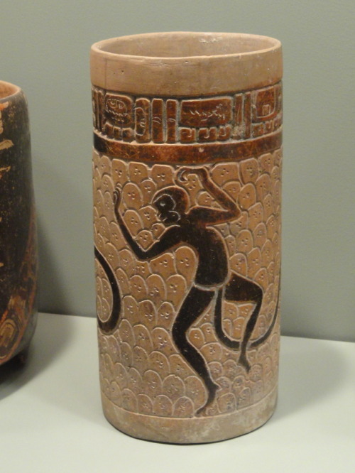 Mayan cylinder vase (earthenware with brown-black slip) depicting spider monkeys.  Artist unknown; c