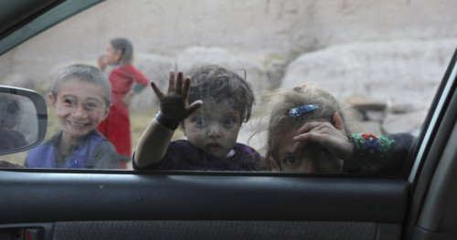 Children look into a car on the outskirts of Jalalabad, Afghanistan. By Rahmat Gul