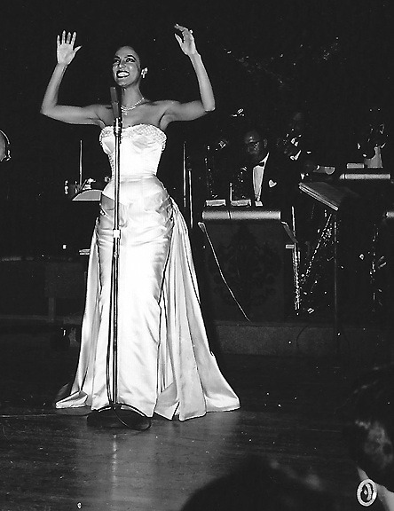 dorothydandridge:“Looking stunning in a a white, body-hugging Travilla gown, she mesmerized th