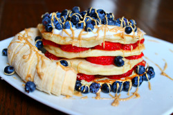 tessredefined:  Breakfast on a rainy morning! Whole wheat pancakes layered with local fresh strawberries topped with organic vanilla yogurt, blueberries, cashew butter, and a banana! 