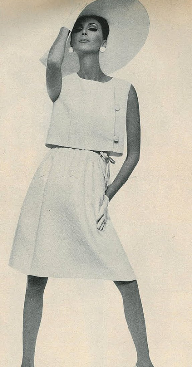 Wilhelmina Cooper in a side-buttoned sleeveless jacket over a white pique drees by Teal Traina, 1965