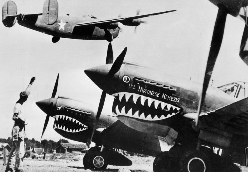 bigglesworld:  Consolidated B-24 with P-40s. The Liberator being cheered on it’s way to another mission